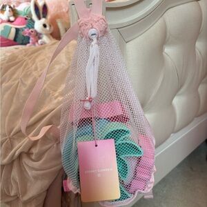 Stoney Clover Lane Pink and White Mesh Drawstring Bag with beach toys